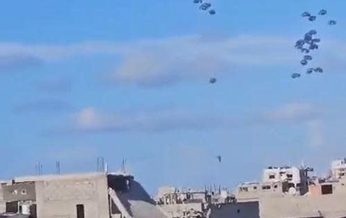 An image from video posted on social media on March 8, 2024, which CBS News could not independently verify, appears to show airdropped aid parcels falling to the ground in northern Gaza, where a witness and officials from the Hamas-run health ministry said 5 people were killed when at least one of the parcels' parachutes failed to properly deploy. One parcel can be seen near the bottom center of this screengrab that was seen falling much more quickly than the rest, with its parachute partially collapsed.  