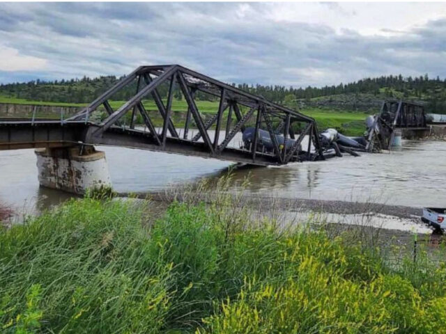 Several train cars are immersed in the Yellowstone River after a bridge collapse near Columbus, Mont., on June 24, 2023. Montana Fish, Wildlife & Parks - Region 5